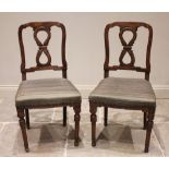 A pair of continental walnut chairs, 19th century, each designed with a carved interlaced 'figure of