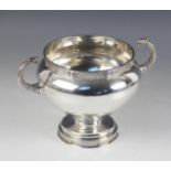 A George V Irish silver twin-handled cup, of compressed globular form raised upon circular foot,
