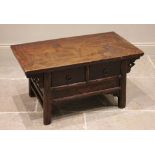 A Chinese elm coffee table, 20th century, the cleated plank top above two frieze drawers, raised