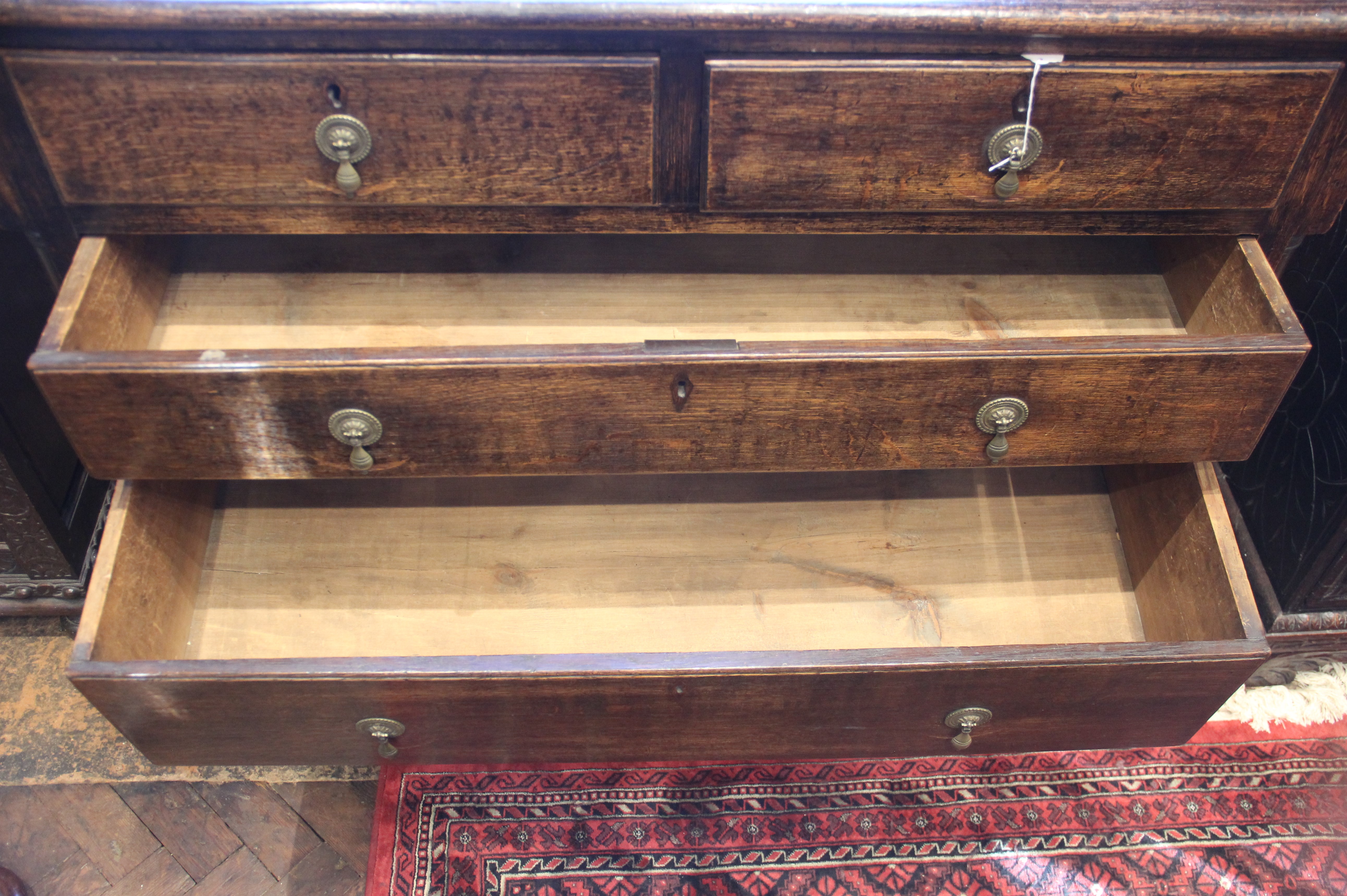 An 18th century oak chest of drawers, the moulded three plank top above two short and three long - Image 4 of 6