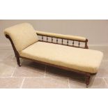 An Edwardian walnut framed and upholstered chaise lounge, the padded scroll end extending to a