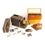 Three boxes of magic lantern slides to include family portraits, social scenes, and topographical,