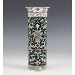 A Chinese porcelain famille noir sleeve vase, 19th/20th century, of typical cylindrical form and