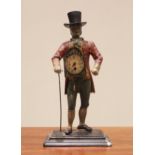 A vintage painted cast metal Dutch figural mantel timepiece, modelled as a clock seller wearing a