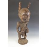 A large carved tribal figure, Cameroon (20th century), in the Congolese style modelled as a figure