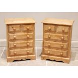 A pair of modern pine bedside chests, each with an arrangement of two short over three long drawers,