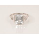 An Art Deco aquamarine and diamond ring, the central emerald cut aquamarine measuring 9.5mm x 7.