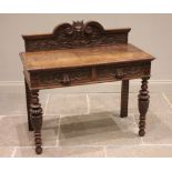 A Victorian carved oak side table, the galleried back centred with a Green Man mask enclosed by