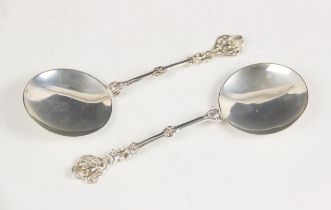 A pair of late Victorian silver serving spoons, each with plain polished silver bowls upon knopped