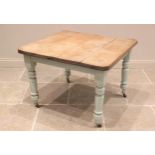 A late Victorian painted scrub top kitchen table, the rectangular top with canted corners, raised