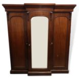 A Victorian mahogany breakfront triple wardrobe, the cavetto cornice above a plain frieze and four