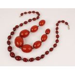 A cherry amber bead necklace, comprising thirty-four polished oval cherry amber beads, measuring