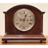 An early 20th century mahogany cased mantel clock, by Russells Ltd, Manchester, the arched case with