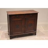 An early 20th century oak Arts and Crafts side cabinet, the rectangular moulded top above two frieze