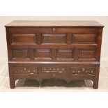 A mid 18th century oak mule chest, the hinged removable cover above an arrangement of five chamfered