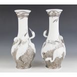 A pair of Lladro Herons' Realm silver lustre vases, each decorated with herons amongst bull rushes