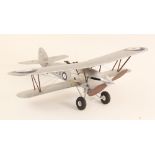 A balsa wood and metal model of a Hawker Hart biplane, approximately 1/18 scale, with pilot and