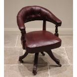 A Victorian mahogany and red leather captain's chair, the arched button back extending to