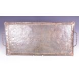 An Arts & Crafts twin handled copper tray by John Pearson, of rectangular form with twist handles,