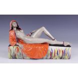 A Peggy Davies artist's proof figure, modelled as a nude in orange cape reclining on a rectangular