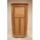A Victorian pine freestanding corner cupboard, the moulded cornice above a single tri-panelled door,