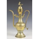 A Tibetan brass ewer and cover, 20th century, of Islamic/Persian form, with Buddhistic decoration