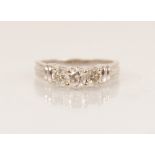 A diamond three-stone 14ct gold ring, the central round brilliant cut diamond weighing approximately