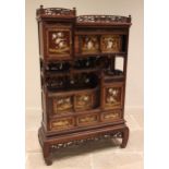A Japanese shibayama cabinet, early 20th century, with an open work foliate gallery above a
