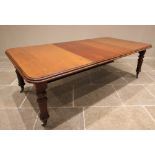 A Victorian mahogany extending dining table, the rectangular moulded top with rounded corners,