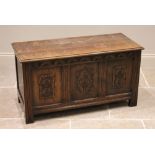 A 17th century style oak blanket chest, 20th century, the rectangular moulded top above a lunette