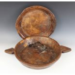 A carved elm twin handled dish, early 19th century, of wide flat-bottomed form, showing later