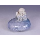 A Royal Doulton Titanian ware grotesque imp, circa 1913, seated on a rock, smoking a pipe and