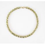 A 9ct gold peridot set line bracelet, designed as a row of oval mixed cut peridots, each measuring