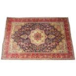 A vintage Persian Tabriz blue ground all over floral design, in red, green and blue colourways,