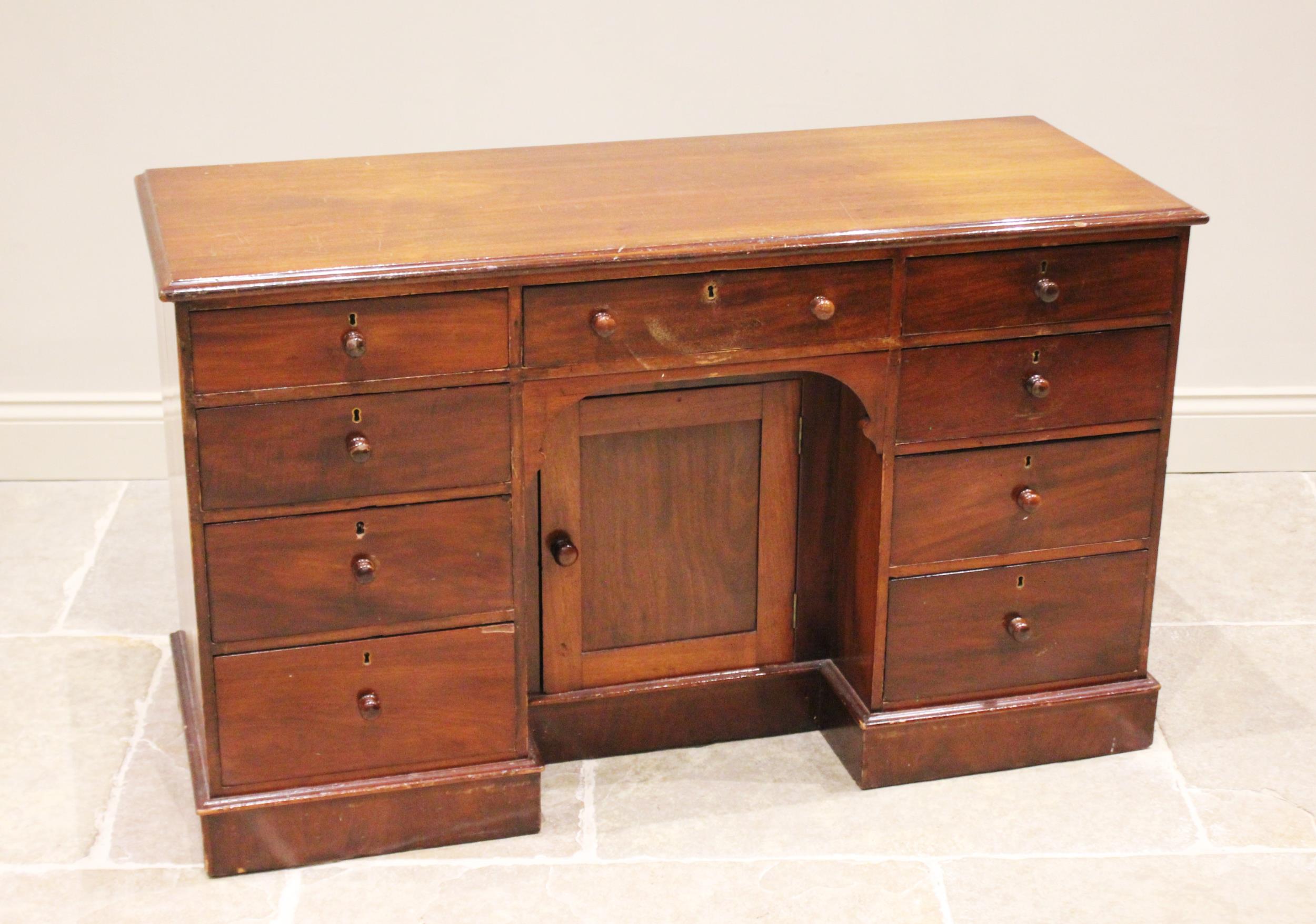 A Victorian mahogany dressing table/desk, the rectangular moulded top above a central recessed