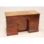 A Victorian mahogany dressing table/desk, the rectangular moulded top above a central recessed