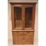 A Victorian glazed pine housekeepers cupboard, the moulded cornice above a pair of glazed cupboard