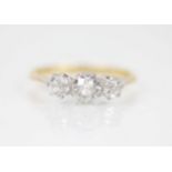A diamond three-stone ring, the central circular old cut diamond measuring approximately 5.2mm x