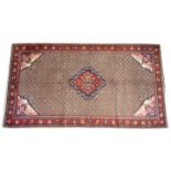 A beige ground Lori Persian rug, the central geometric foliate medallion upon a lattice ground