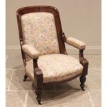 A Victorian walnut and upholstered drawing room chair, the concave padded back extending to straight