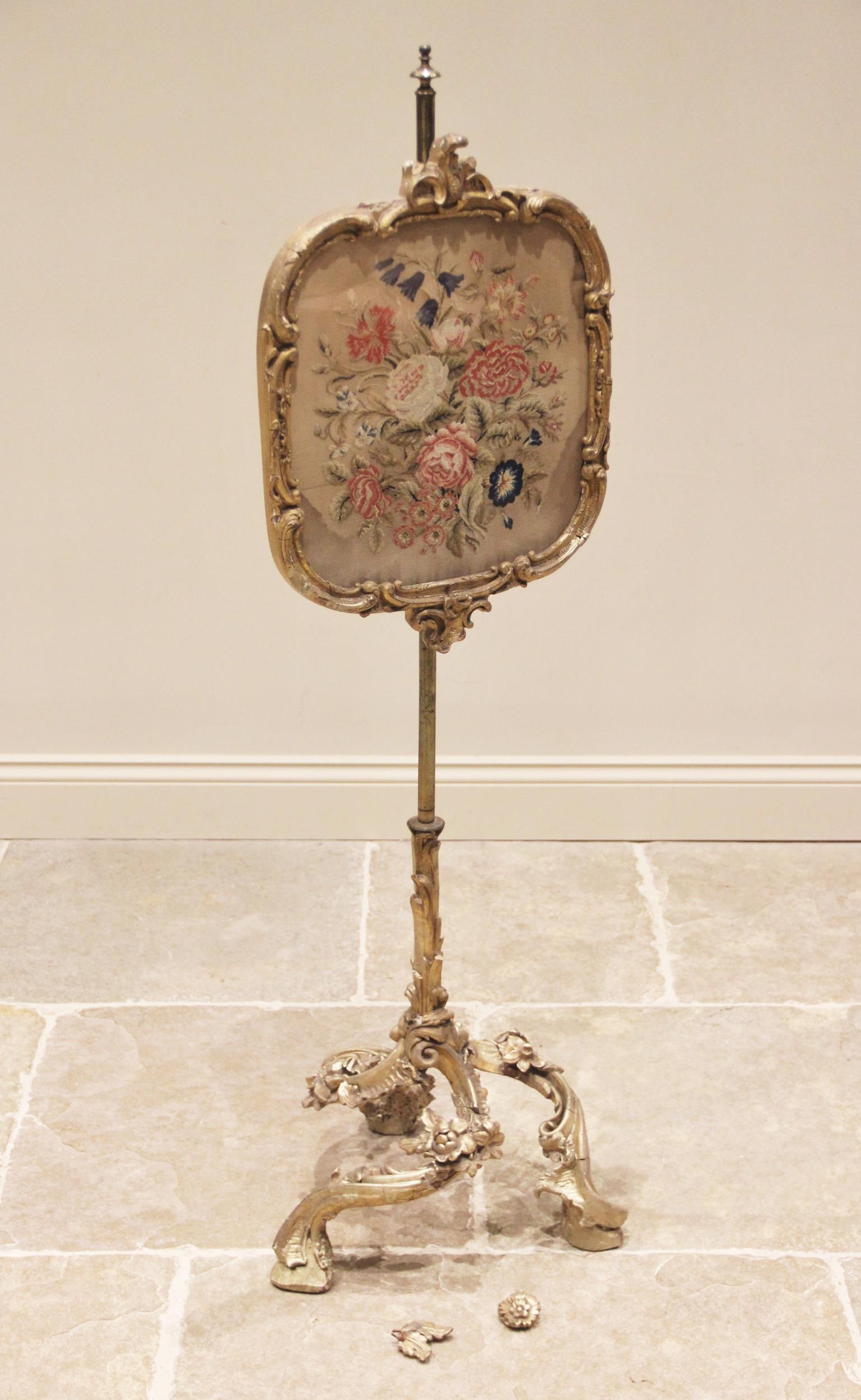 A late 19th century gilt gesso and brass pole screen, the tapestry work glazed panel within a 'C'
