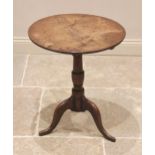 A George III oak tripod table, the circular top raised upon a cup and baluster pedestal extending to
