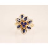 A sapphire and diamond floral cluster ring, the tiered cluster designed as three central sapphires