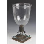 A glass storm candle lamp, late 19th/early 20th century, of typical inverted bell form with