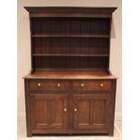 A George III style oak Welsh dresser, 20th century, the high back with a moulded cornice over two