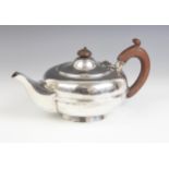 A George V silver teapot, Chester 1925 (maker's marks worn), of compressed ovoid form with banded