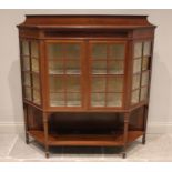 An Edwardian mahogany and satinwood crossbanded display cabinet, of angular bowfront form, with a