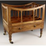 A Regency mahogany canterbury, with three divisions above a frieze drawer