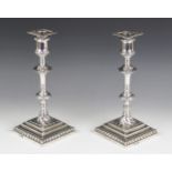 A pair of George III silver candlesticks, hallmarked I.W (possibly John Weldring or James Wibird),