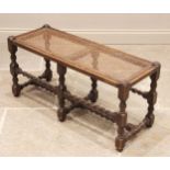 An oak and rattan long stool/window seat, early 20th century, the rectangular cane work seat